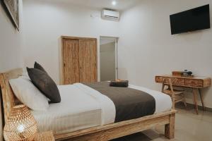Cama ou camas em um quarto em pondok arsa canggu