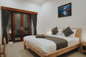 Cama ou camas em um quarto em pondok arsa canggu