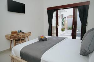 Cama ou camas em um quarto em pondok arsa canggu