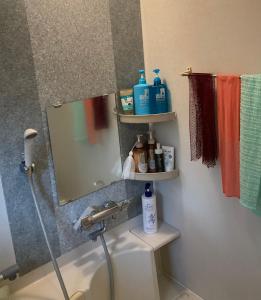 a bathroom with a sink and a mirror and towels at Siodomi Marinki share wood lodge, pets allowed in Ōkuki +30 photos