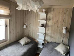 a bedroom with a bed and a book shelf at Noras Pitragā in Pitragutsiyeme