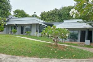 a house with a tree in front of it at Sirimaya Garden Home & Residence in Bang Rak Beach +7 photos