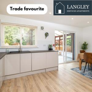 una cucina con un lavello e un piano di lavoro di LANGLEY HOUSE central LOCATION 5 bed all double with smart TV 3 BATHROOMS Loved by TRADES teams ideal for LONG STAYS contact langley cottages and apartments a Dundee