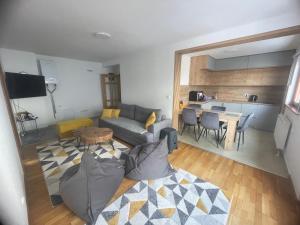 a living room with a couch and a table at Montis Vlasic Apartment 2 in Vlasic
