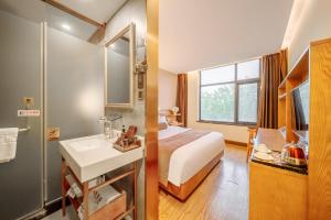 Postel nebo postele na pokoji v ubytování Cosy Feeling Hotel - Beijing Headquarters Xinfadi