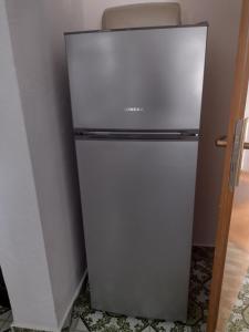 a refrigerator in a corner of a room at APARTMANI ALEN in Dinjiška