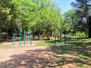 a playground in a park with trees at APARTMENTS JADRANKa in Omišalj +117 photos