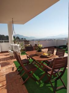 a wooden table and chairs on a patio at Villa Fenix in Gandía