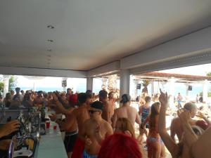 a crowd of people at a party at the beach at Quayside Village Hotel in Kavos