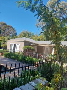 a house with a fence in front of it at Pool House in Albury