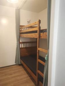 a bunk bed in a small room with a ladder at studio cabine avec véranda et terrasse in Luchon