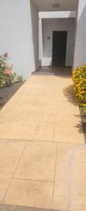 an empty hallway of a white building with flowers at Fuerte Confort in La Oliva