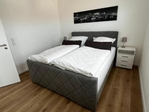 a bedroom with a large bed with white sheets at Fewo Klein Venedig in Bamberg