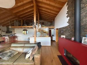 a living room with a couch and a brick wall at Chalet Hakuna Matata Ovronnaz in Ovronnaz