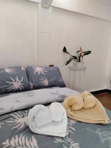 a living room with two towels on a bed at Del Mar Transient House in Tarlac