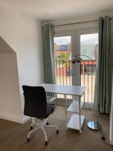 a desk and a chair in a room with a window at country retreat in Sutton Bonington