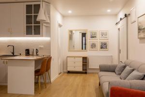 a kitchen and living room with a couch and a table at Mestia Apartments in Mestia