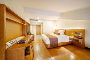 Postel nebo postele na pokoji v ubytování Cosy Feeling Hotel - Beijing Headquarters Xinfadi