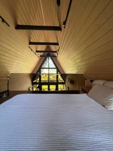a large white bed in a room with a window at Valley Hills-котедж на схилах гір з чаном-джакузі in Slavske