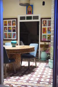 a dining room with a table and chairs at Riad Dar Afram in Essaouira +79 photos