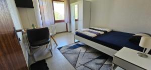 a small room with a bed and a desk at ÖzSel Home in Göttingen