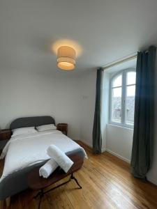 a bedroom with a bed with two towels on it at CHTX Hôtel particulier Albert Ier in Châteauroux