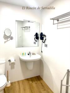 a bathroom with a sink and a mirror at El Rincón de Serradilla in Serradilla +14 photos