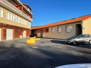a rubber duck in a parking lot next to a building at Studio Ô terrasses de Virieu in Pélussin