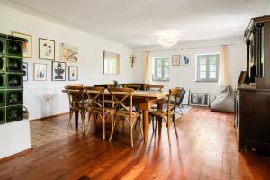 a dining room with a wooden table and chairs at Landhaus Pößnitz in Leutschach