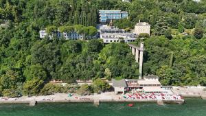an aerial view of a resort with a beach and buildings at Hotel Riviera & Maximilian's in Trieste