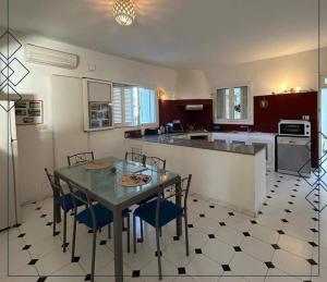 a kitchen with a table and chairs and a counter at Esmeralda in Djerba