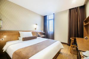 Postel nebo postele na pokoji v ubytování Cosy Feeling Hotel - Beijing Headquarters Xinfadi