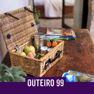 a basket of fruit and vegetables on a table at Casa Outeiro 99 in Paredes de Coura