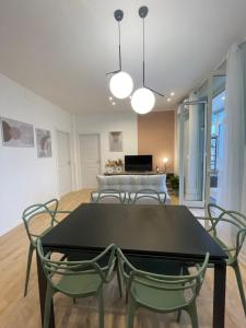 a dining room with a black table and chairs at Politeama Charming Apartment in Palermo +44 photos