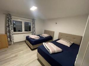 a bedroom with two beds and a window at Schöne EG Wohnung in Kolbermoor