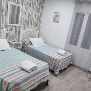 a room with two beds and a window at Mojácar Vibes 1 Línea de Playa in Mojácar