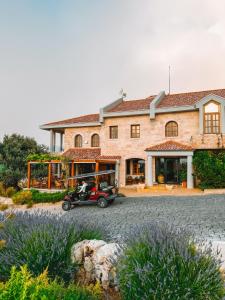 a house with a motorcycle parked in front of it at KCOR Hotels in Ḩārat at Taḩtā +49 photos