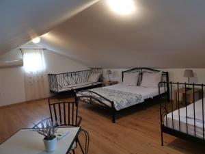 a room with a bed and a table and a couch at Robinson crusoe style house "MASLINA'' in Škrip +38 photos