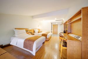 Postel nebo postele na pokoji v ubytování Cosy Feeling Hotel - Beijing Headquarters Xinfadi
