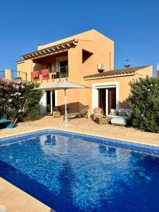 a large swimming pool in front of a house at CASA Luz Solar - Finca mit privatem Pool nahe Strand & Santanyí in Cala Santanyi