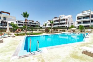 a swimming pool in front of some apartment buildings at LMS48- Roof terrace, jacuzzi & sauna in Estepona