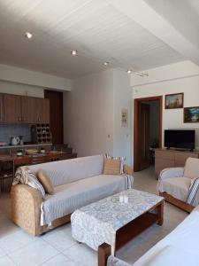 a living room with a couch and a table at Efi's Guest House in Agios Dimitrios