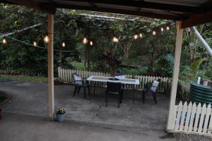 a table and chairs under a pavilion with lights at Amamoor - Living Waters in Amamoor