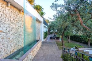 a walkway to a house with a glass wall at Virgilio Grand Hotel in Sperlonga