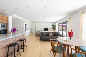 a living room with a couch and a table and chairs at Villa Korsan- 8 Bedroom Villa with Private Pool and Sea View in Kas