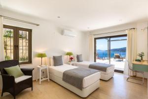a bedroom with two beds and a view of the ocean at Villa Korsan- 8 Bedroom Villa with Private Pool and Sea View in Kas +25 photos