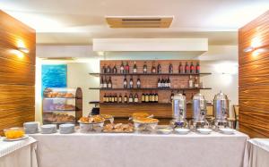 a table with food and bottles of wine on it at Virgilio Grand Hotel in Sperlonga