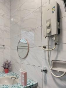a bathroom with a sink and a mirror at Beach side Cozy Bungalow in Tanjung Bungah +63 photos