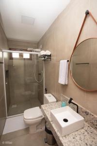 a bathroom with a toilet and a sink and a shower at Villaz Lençóis Maranhenses in Santo Amaro