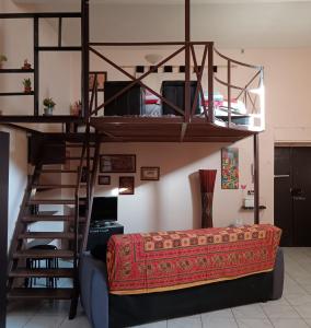 a bunk bed with a couch in a room at 'In My Place' Monolocale soppalcato Open space in Genzano di Roma